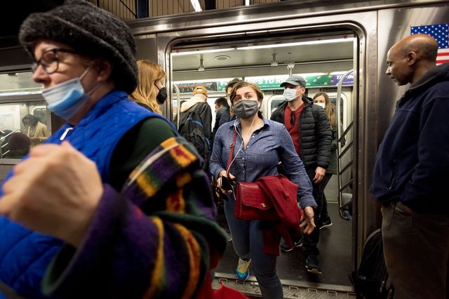 People enter and exit a New York City subway car, April 21st, 2022.